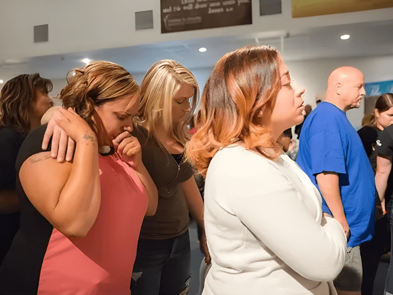 People praying together in a supportive community