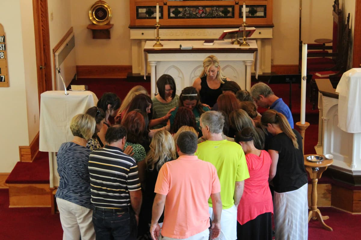 Community prayer circle at a church altar