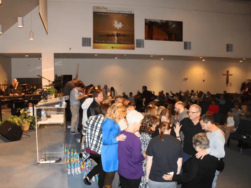 People in prayer at a recovery event