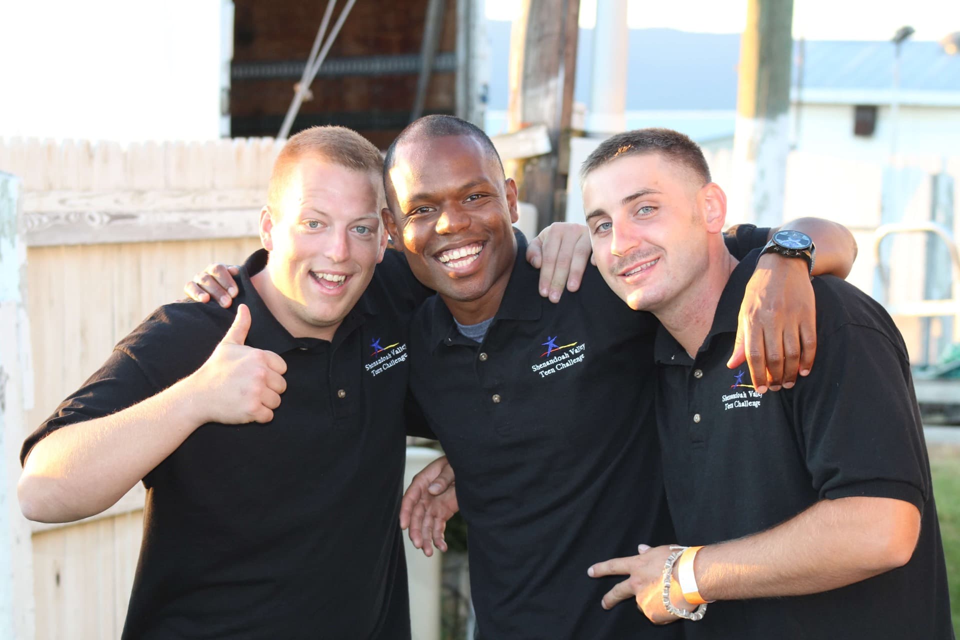 Teen Challenge brothers standing together in community outside their facility
