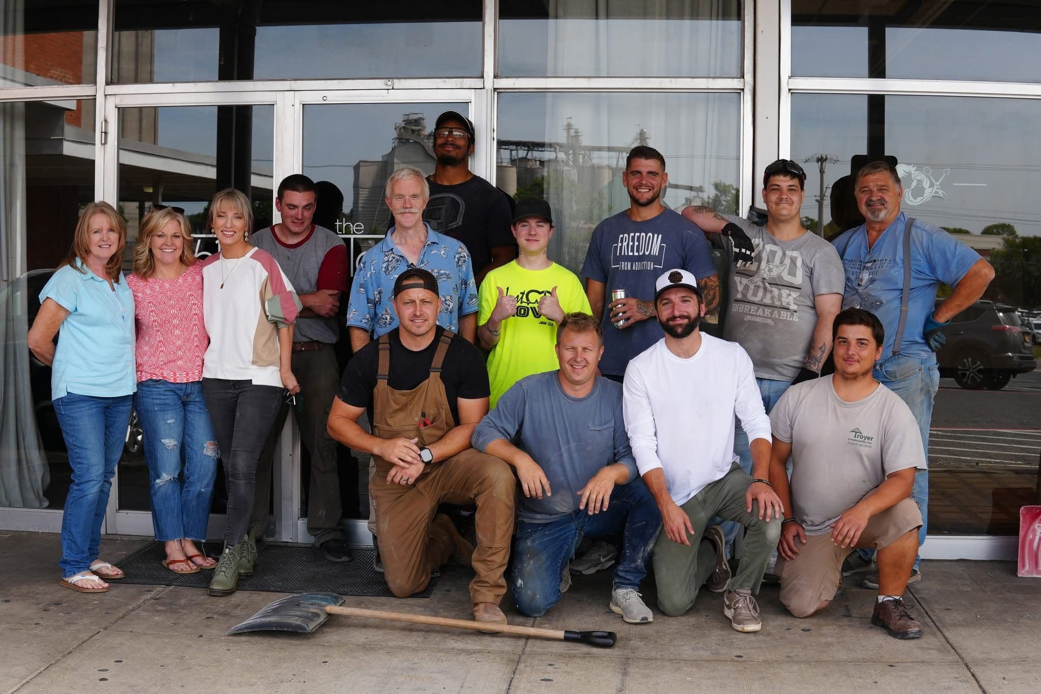 Shenandoah Valley Teen Challenge students and Table 61 volunteers pose together outside The Table 61's new space in Harrisonburg, Virginia after a day of renovation work.