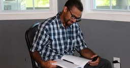A man studying with a book open during a class at Teen Challenge