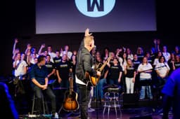 Matthew West performing acoustic worship with SVTC students in Freedom From Addiction shirts on stage at Winchester Church of God in Winchester Virginia