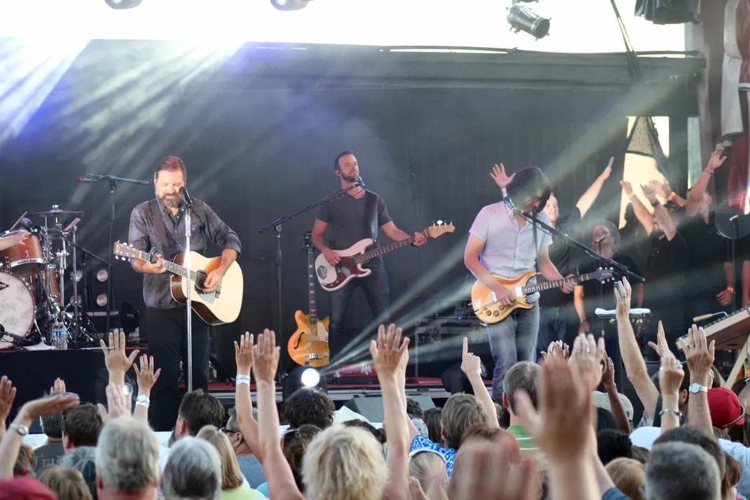 Third Day performing on stage at the Shenandoah County Fair in Woodstock Virginia with crowd raising hands