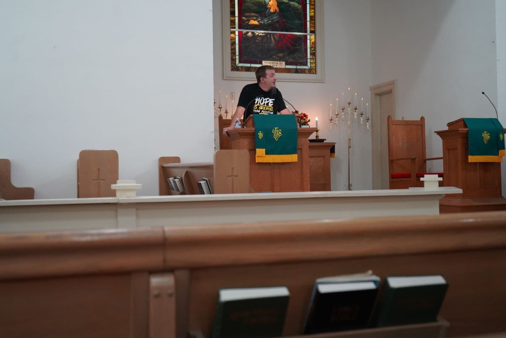 Justin Franich speaks from the pulpit at Valley Pike Church of the Brethren in Maurertown, Virginia wearing a "Hope Is Greater Than Addiction" shirt during a Sunday morning Teen Challenge service.