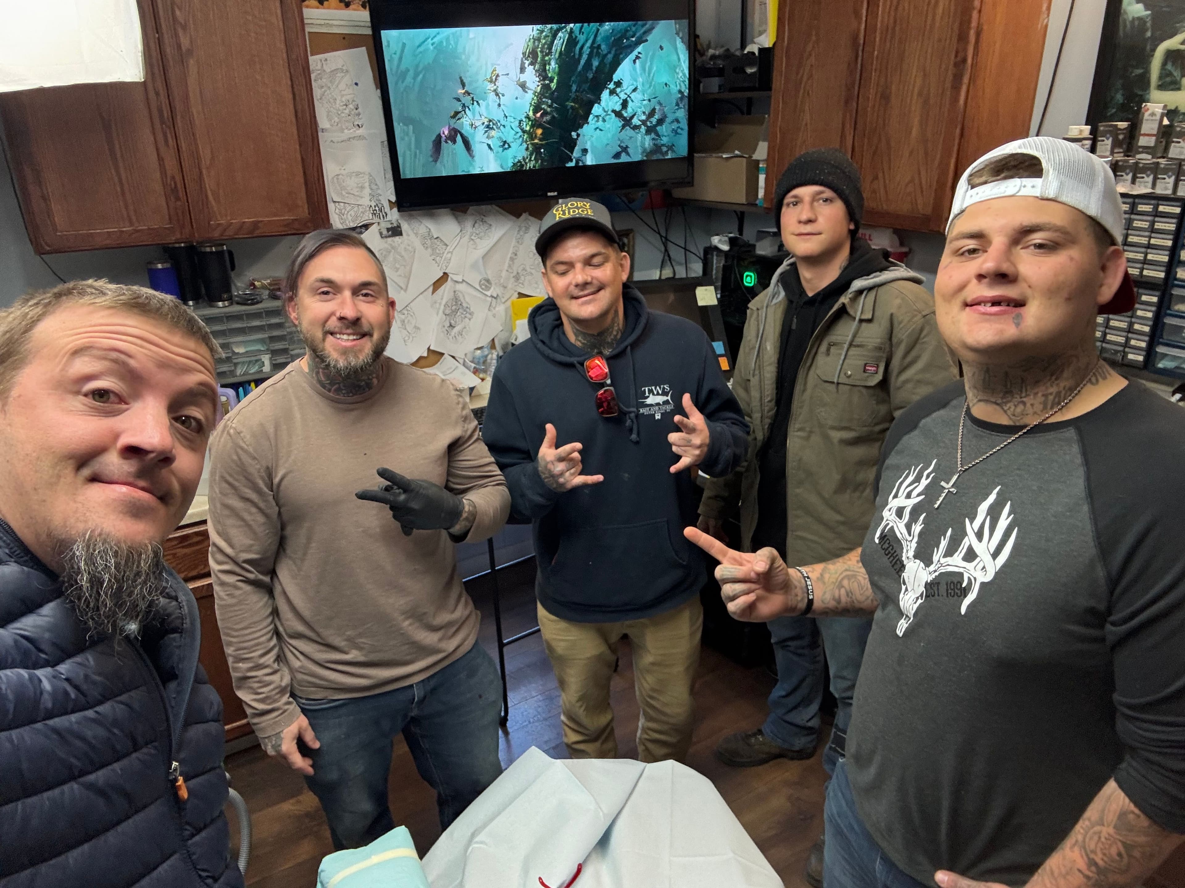 Justin Franich and Teen Challenge students with Michael Hiles at Dreamland Tattoo during a free tattoo removal session in Mount Jackson, Virginia.