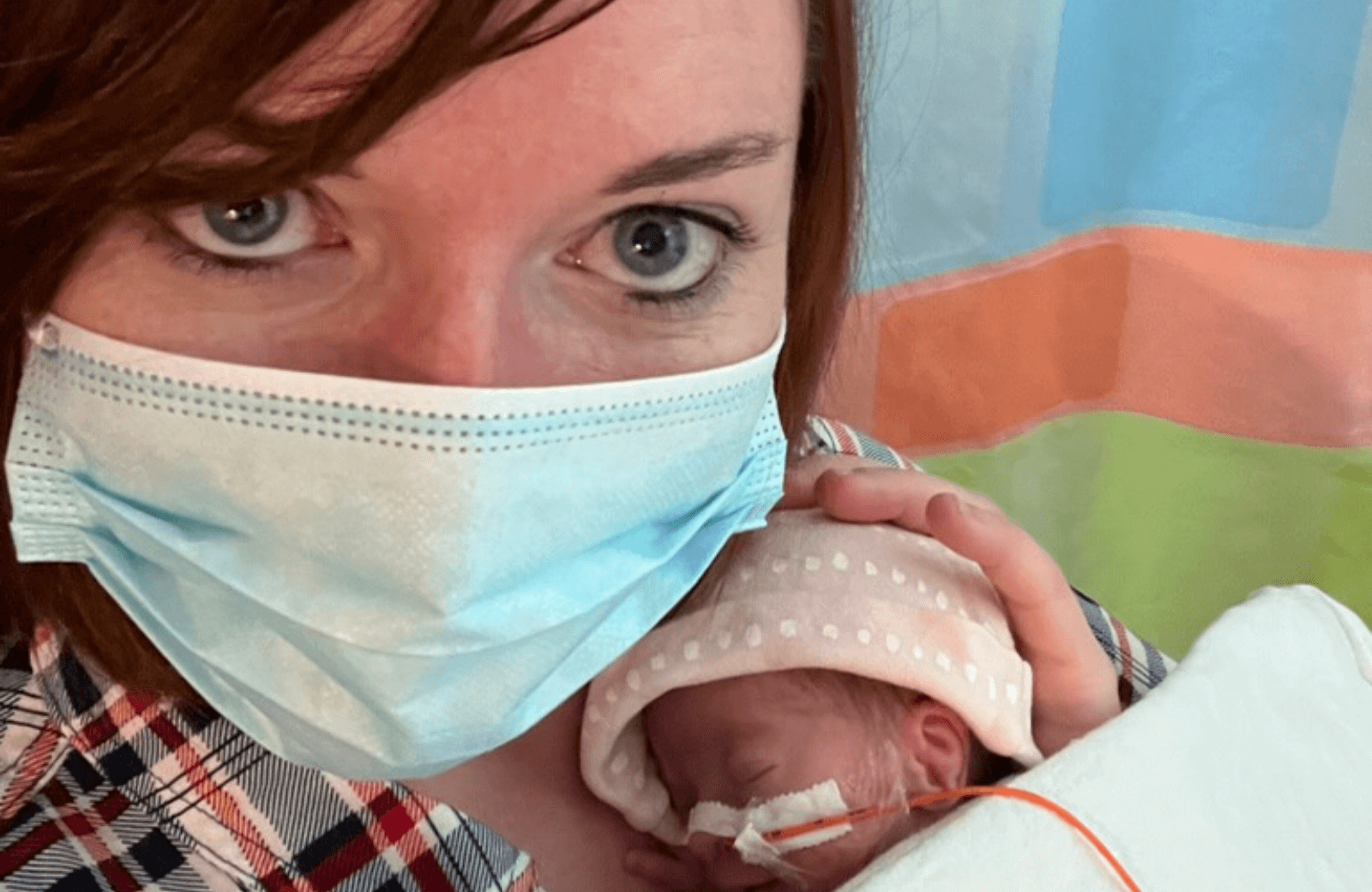 Woman in medical mask holding a premature baby in the NICU, tender moment of care and uncertainty